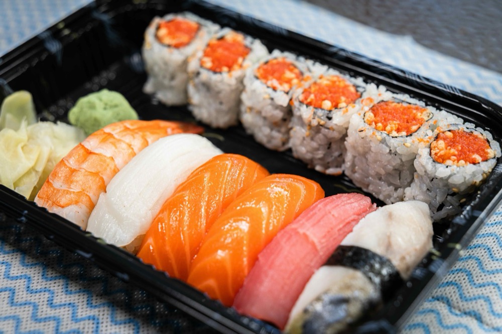 Mixed sushi platter with salmon, tuna, shrimp nigiri and tobiko maki rolls at AB Fish Market